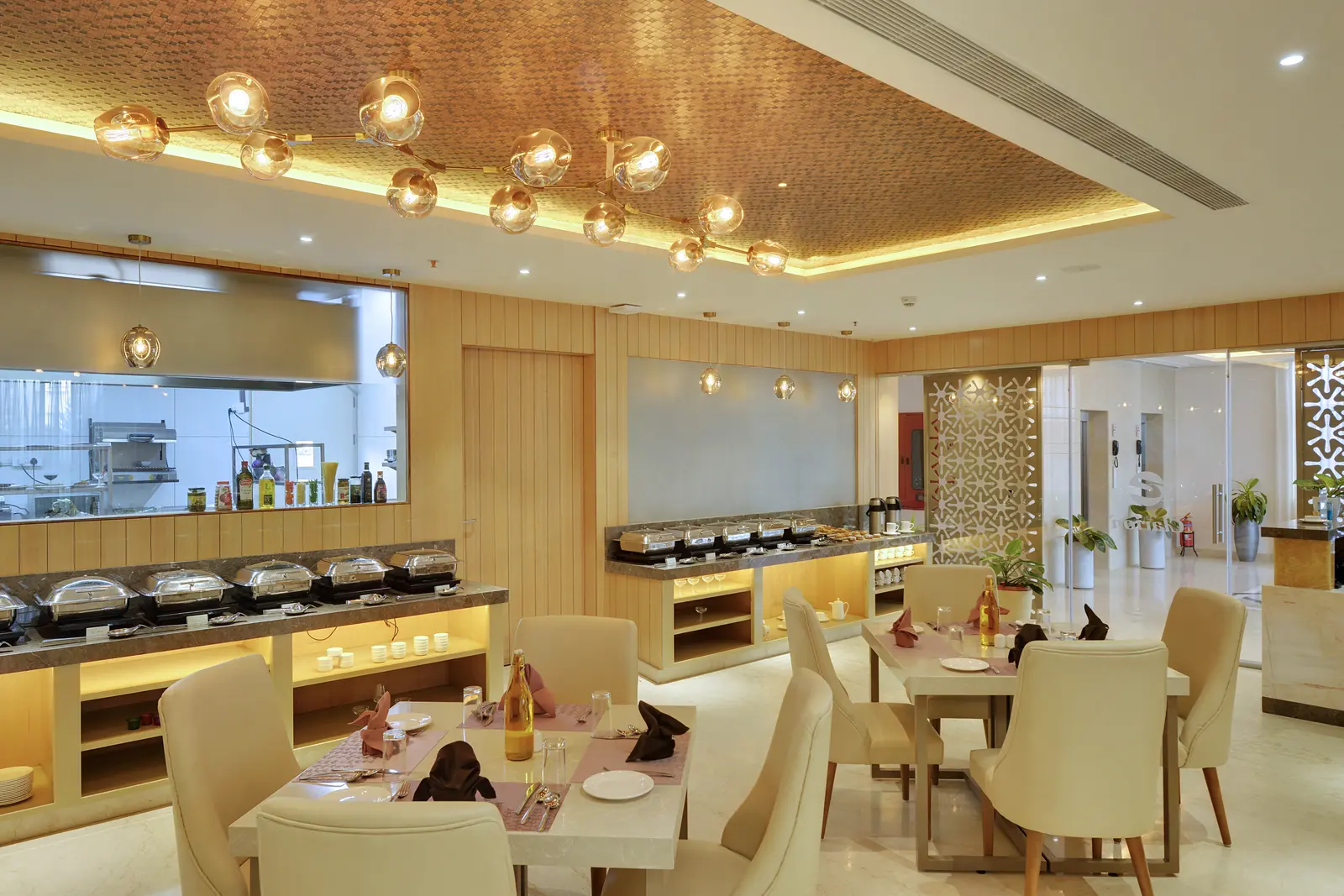 Buffet counter and table seating at Choice 64 restaurant, Clarion Bangalore